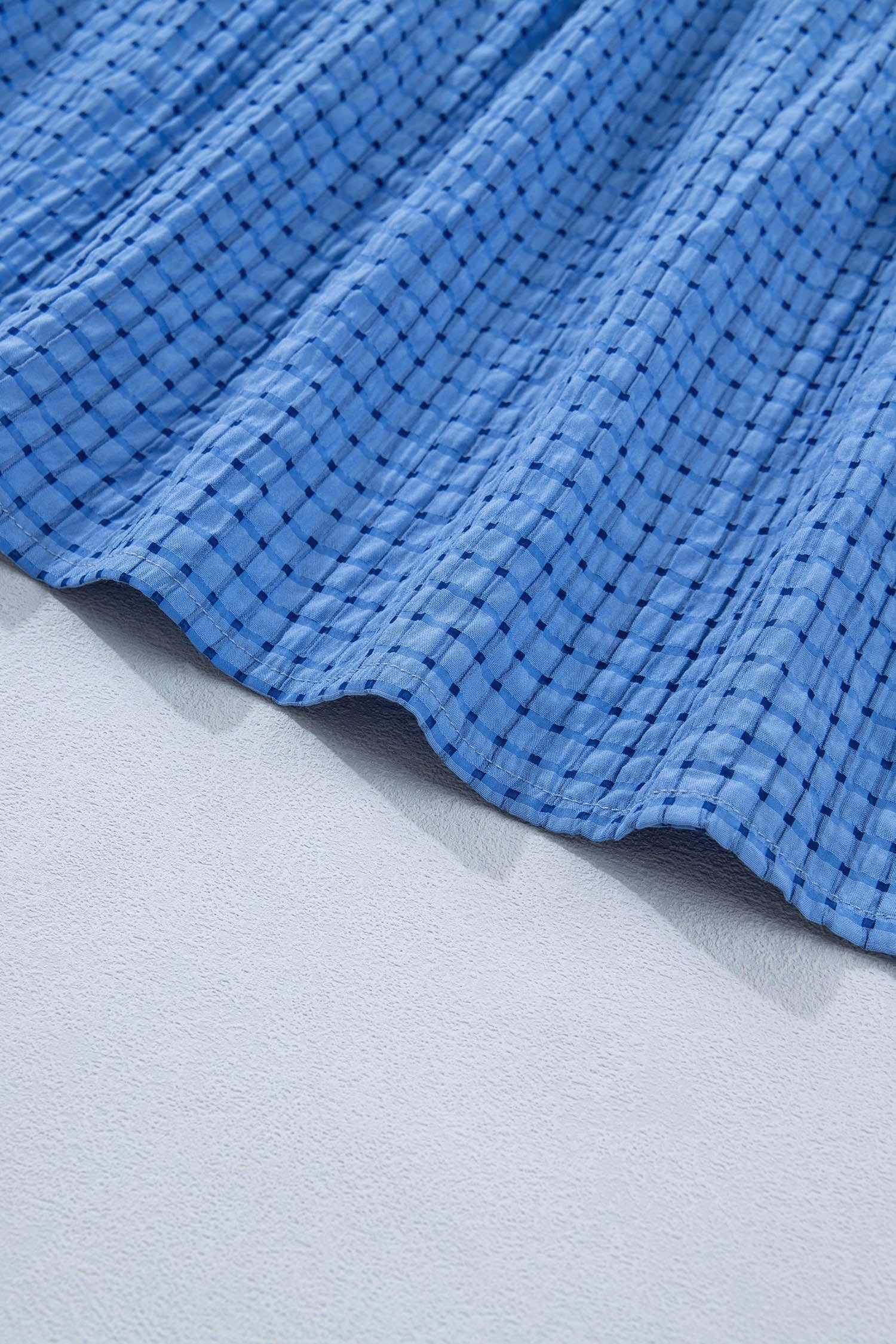 Dusk blue tiered dress hem with textured check pattern