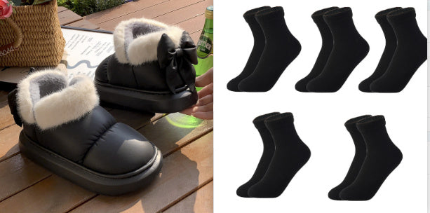 Black ankle winter boots with faux fur cuffs, bow detail, and thick sole