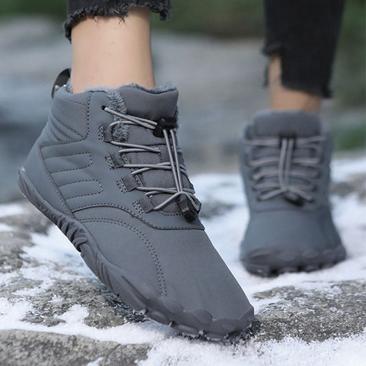 Winter slip-on boots in gray with lace-up front and thick tread sole, shown on snow.