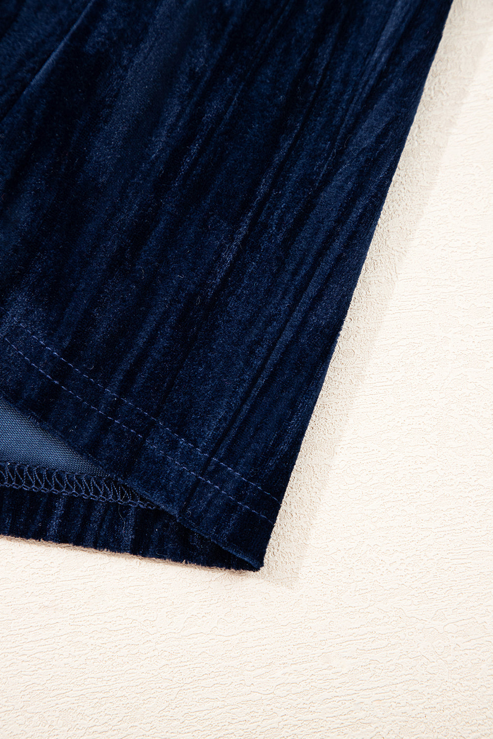 Navy blue dress hem with gathered ruffle and elastic stitching detail