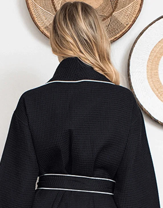 Women’s knee-length waffle robe, black with white piping and tie belt