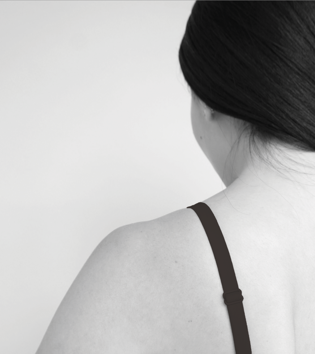 Black adjustable bra strap on upper back with centered back hardware