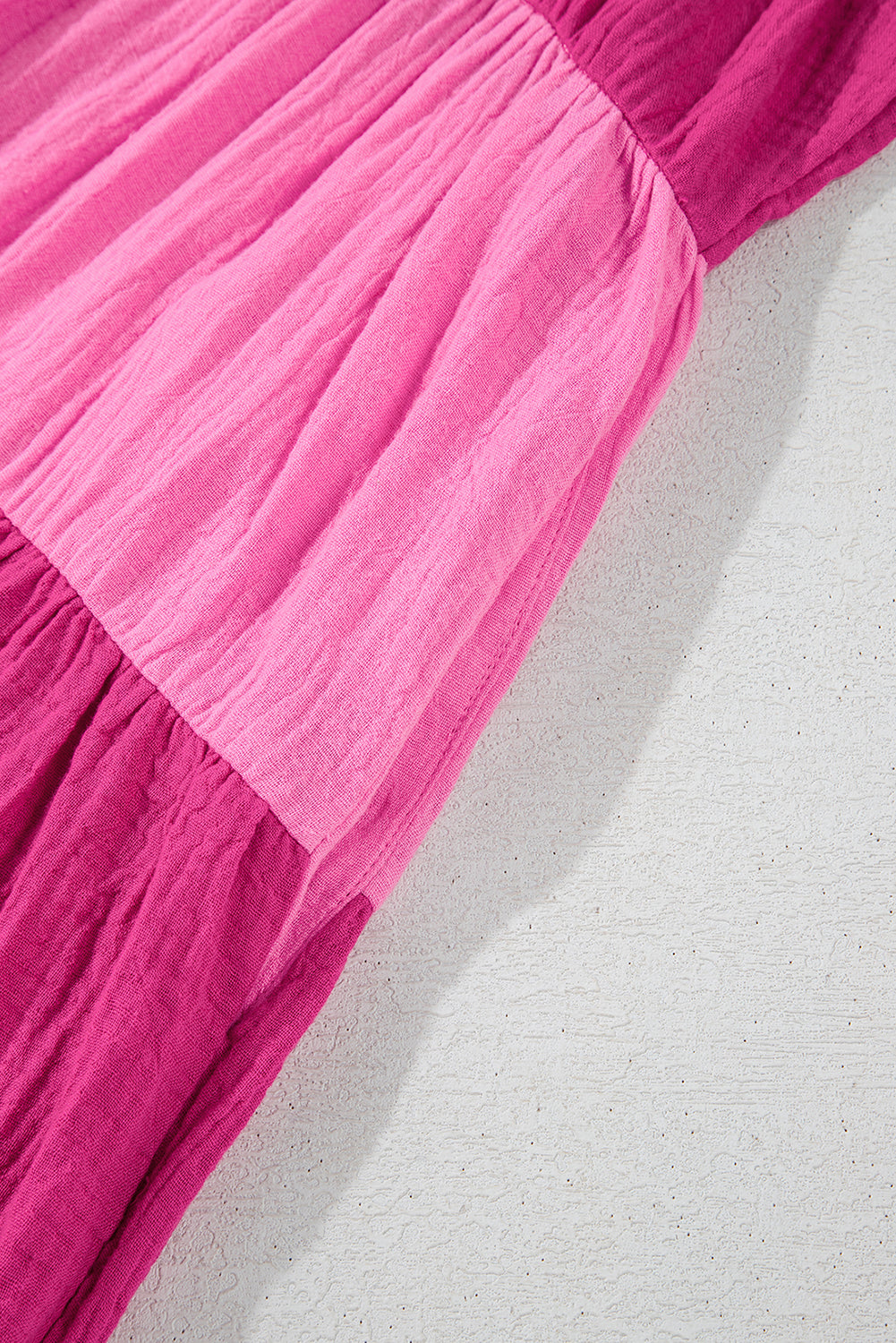 Pink tiered mini dress close-up of layered skirt tiers