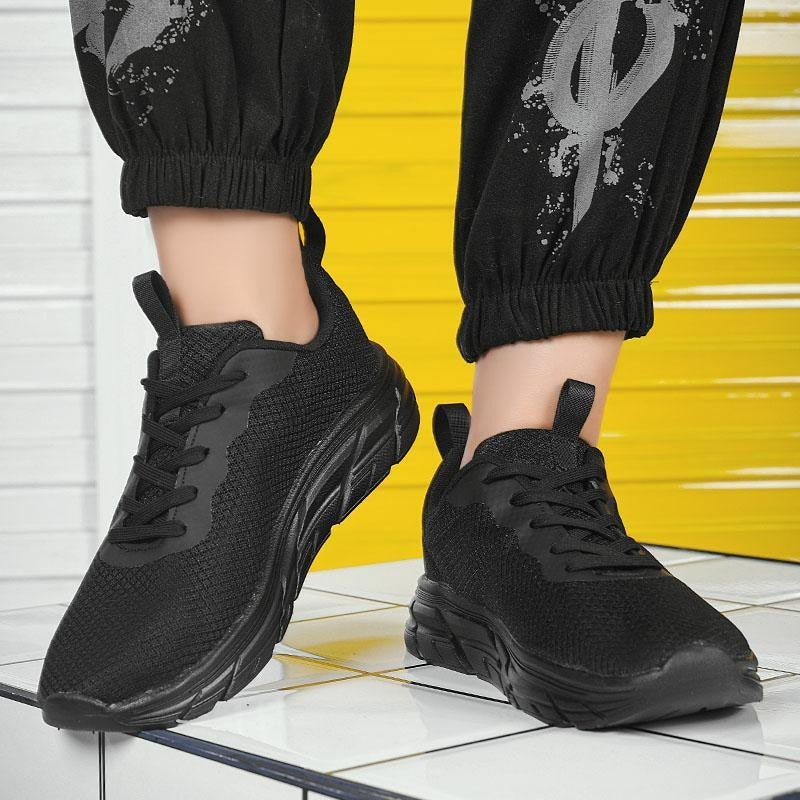 Men's mesh sneakers in black with white outsole and lace-up front
