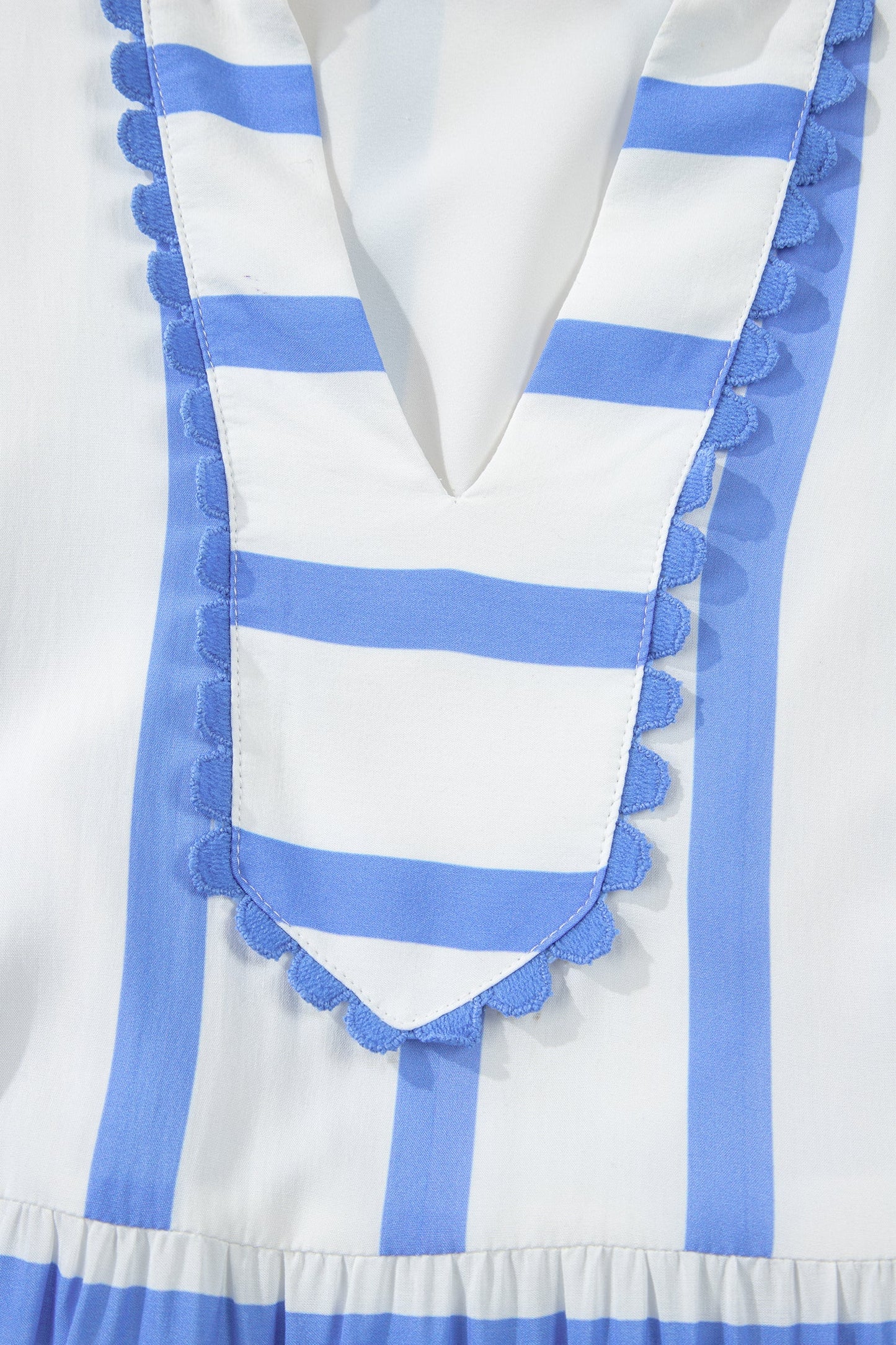 Blue-striped V-neck dress with layered ruffle edging and short puff sleeves
