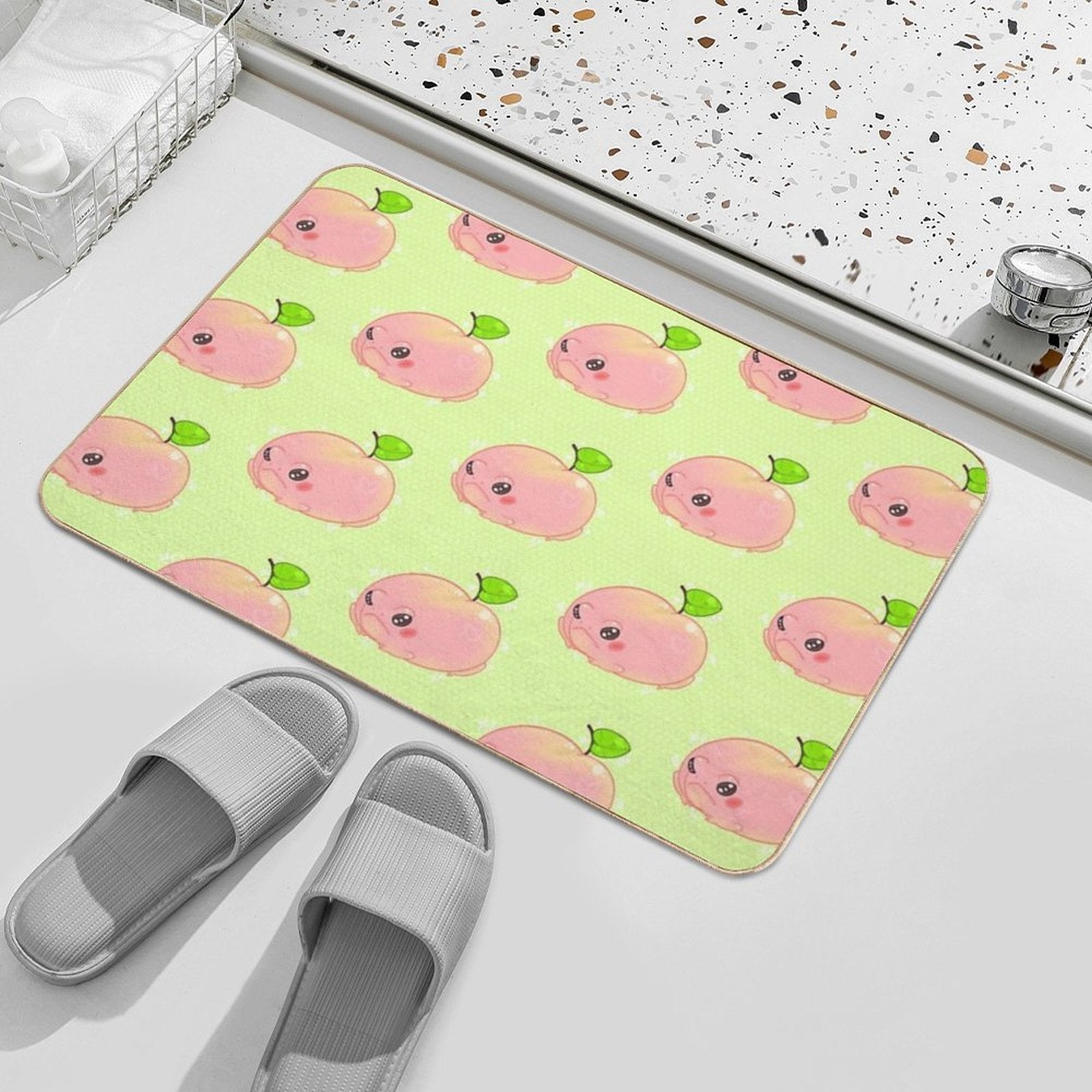 Peach frog bath mat laid flat, repeating pink frog faces and green leaf accents