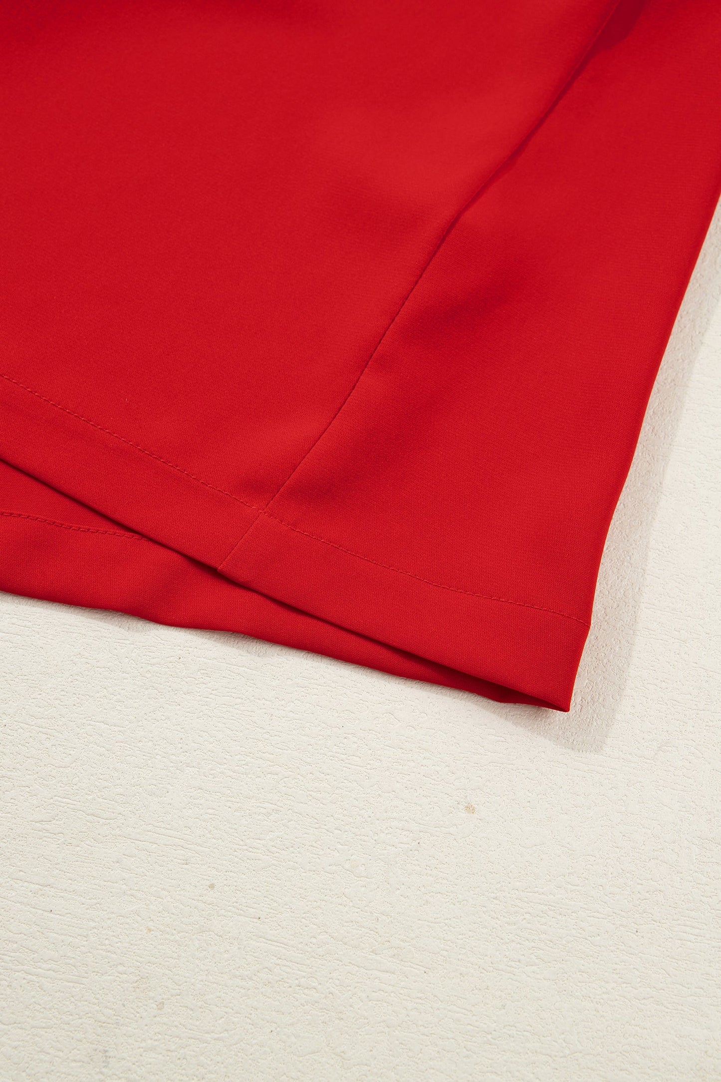 Red pajama shorts hem with stitched seam and white trim detail