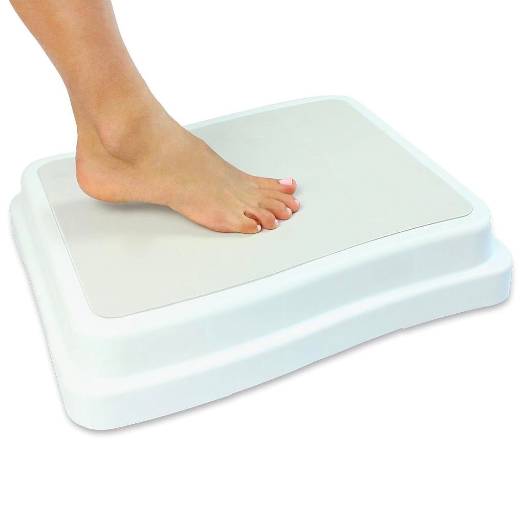 Bed step with textured top and rounded edges, light blue/gray, foot resting on surface