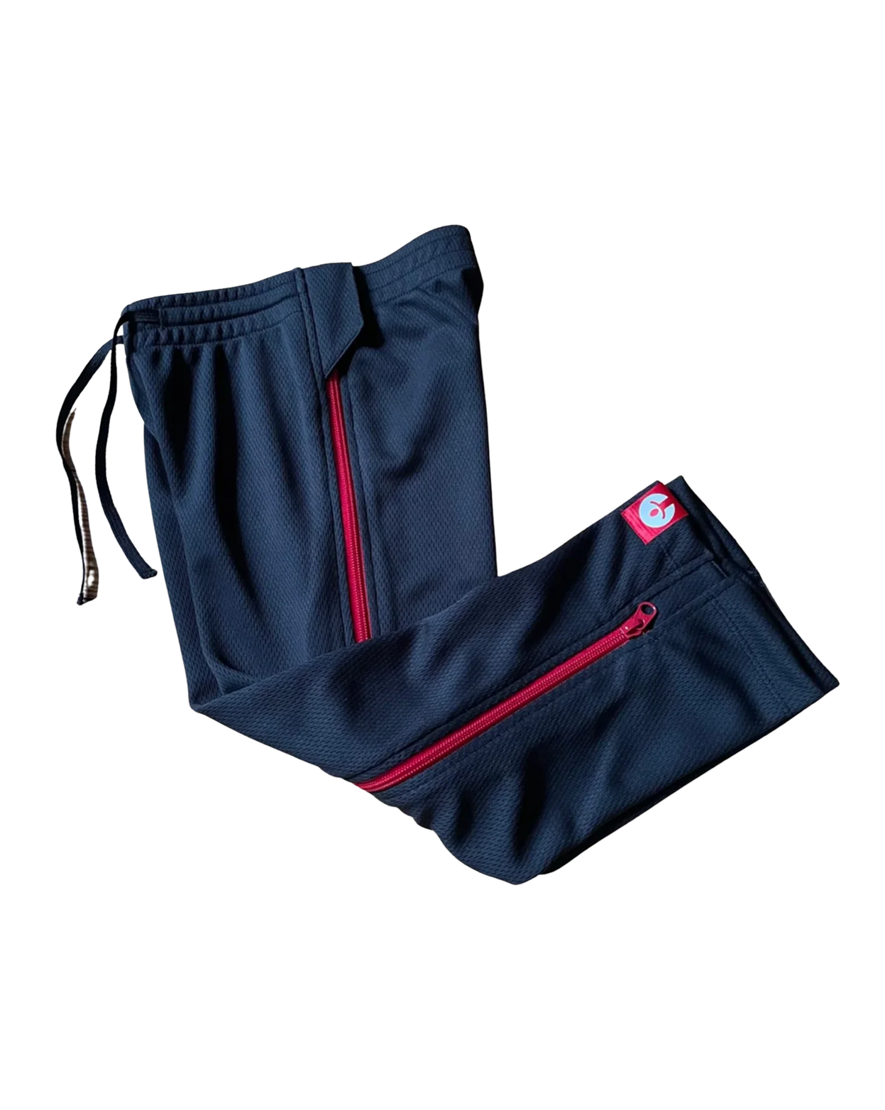 Navy blue pants with red zippers on a white background