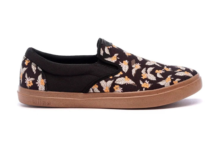 Men's slip-on sneakers with black floral canvas upper and tan rubber sole
