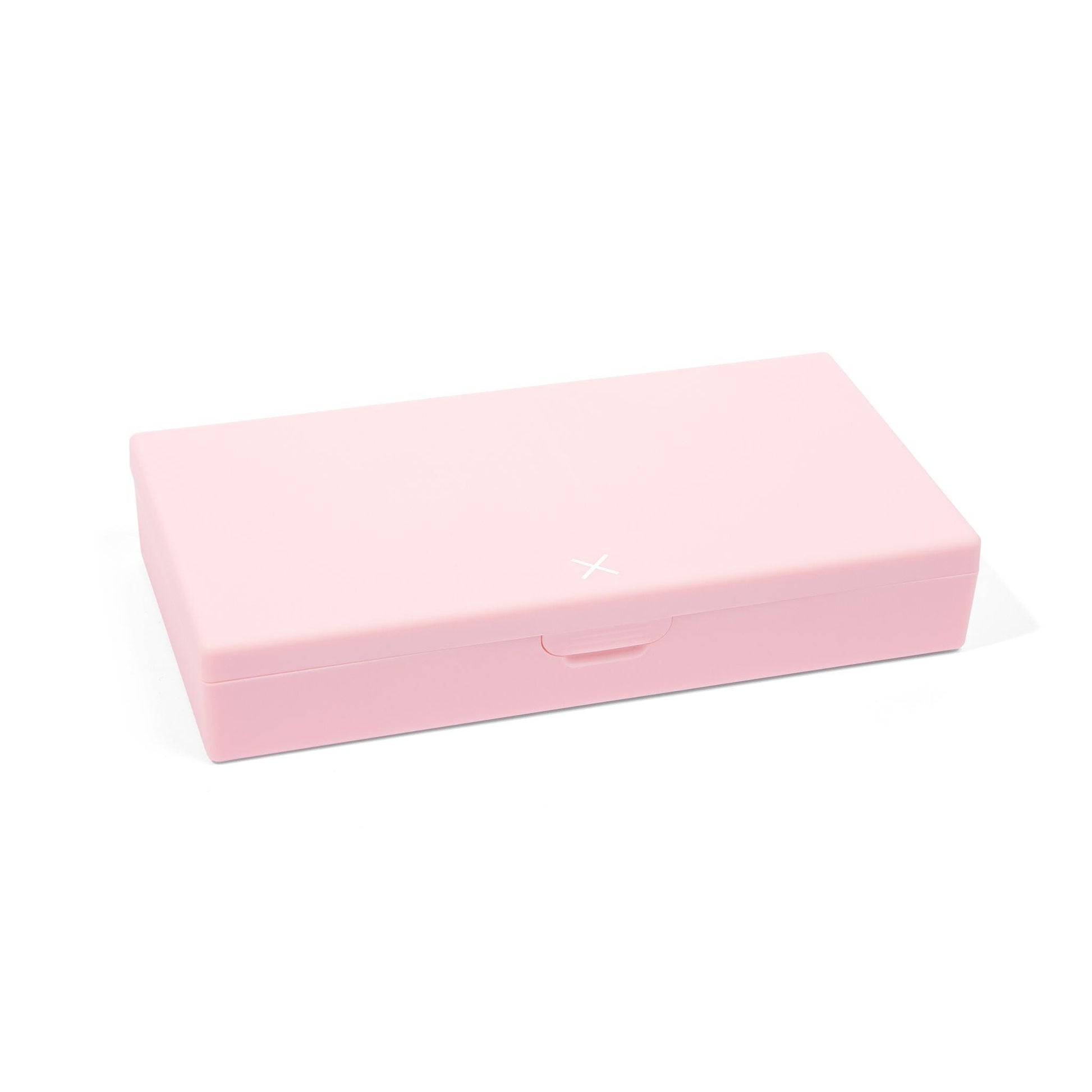 Blush pink AM/PM pill box closed with small clasp and X decoration