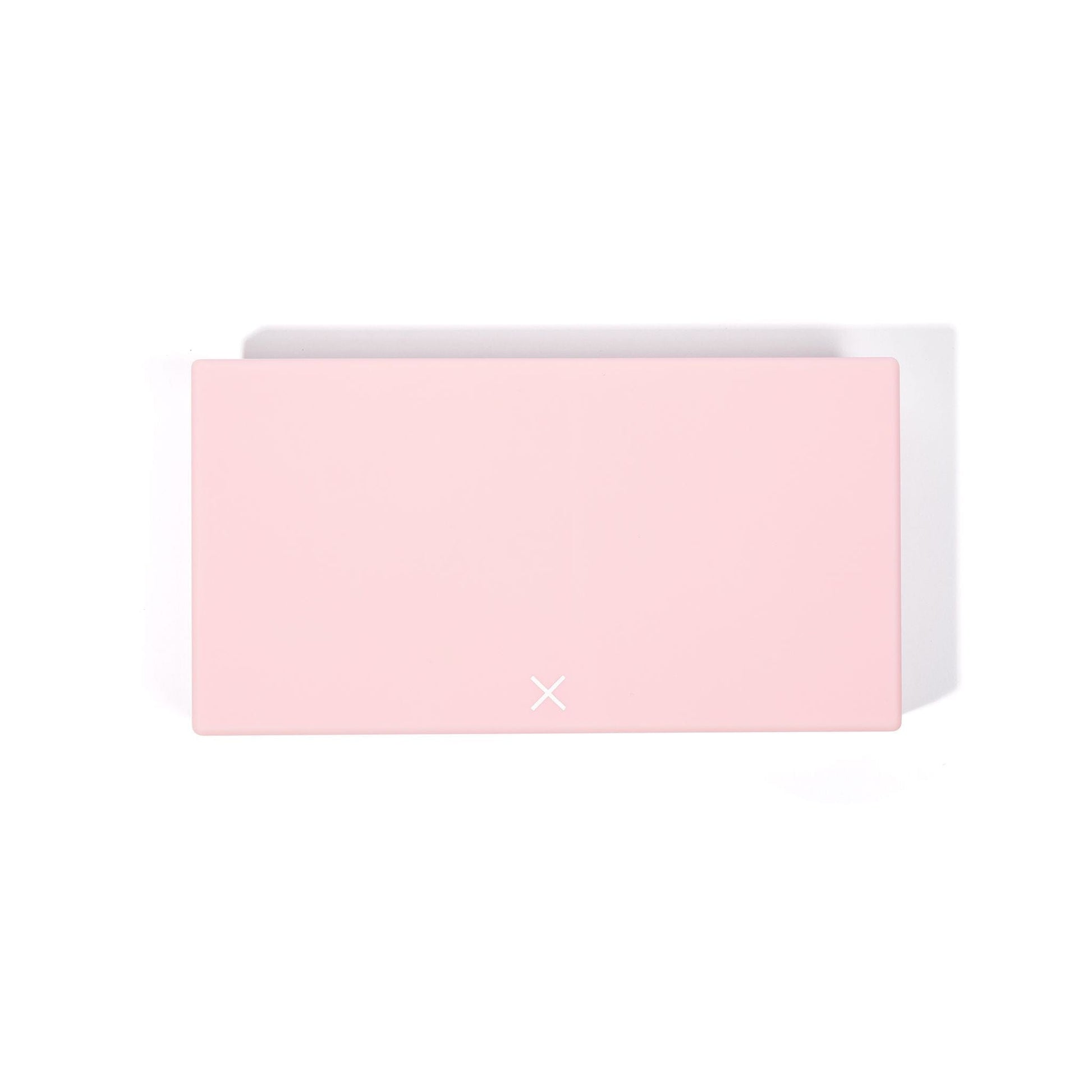 Blush pink AM/PM pill box with lid partially open and clasp tab visible