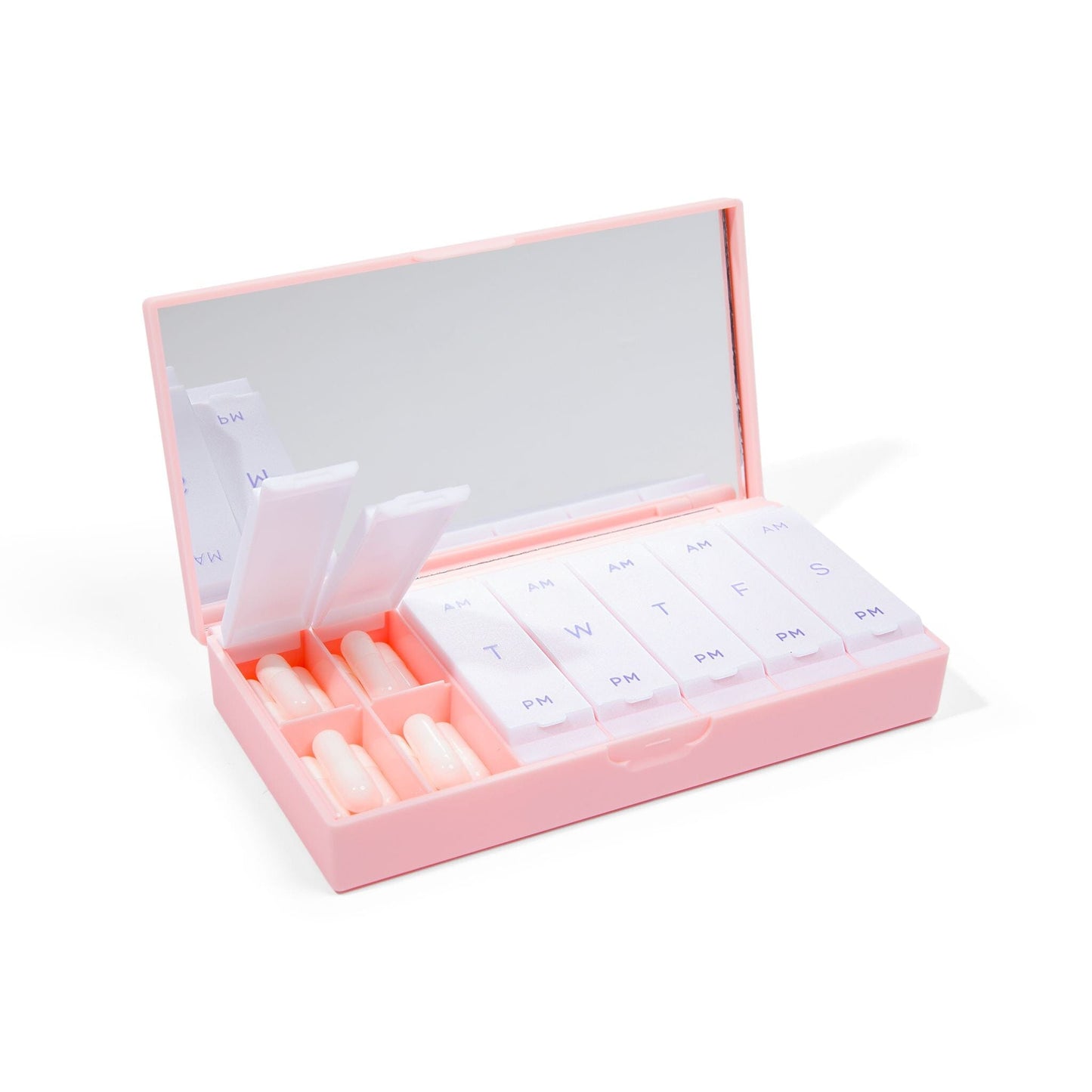 Blush pink AM/PM pill box open with labeled day compartments and slots