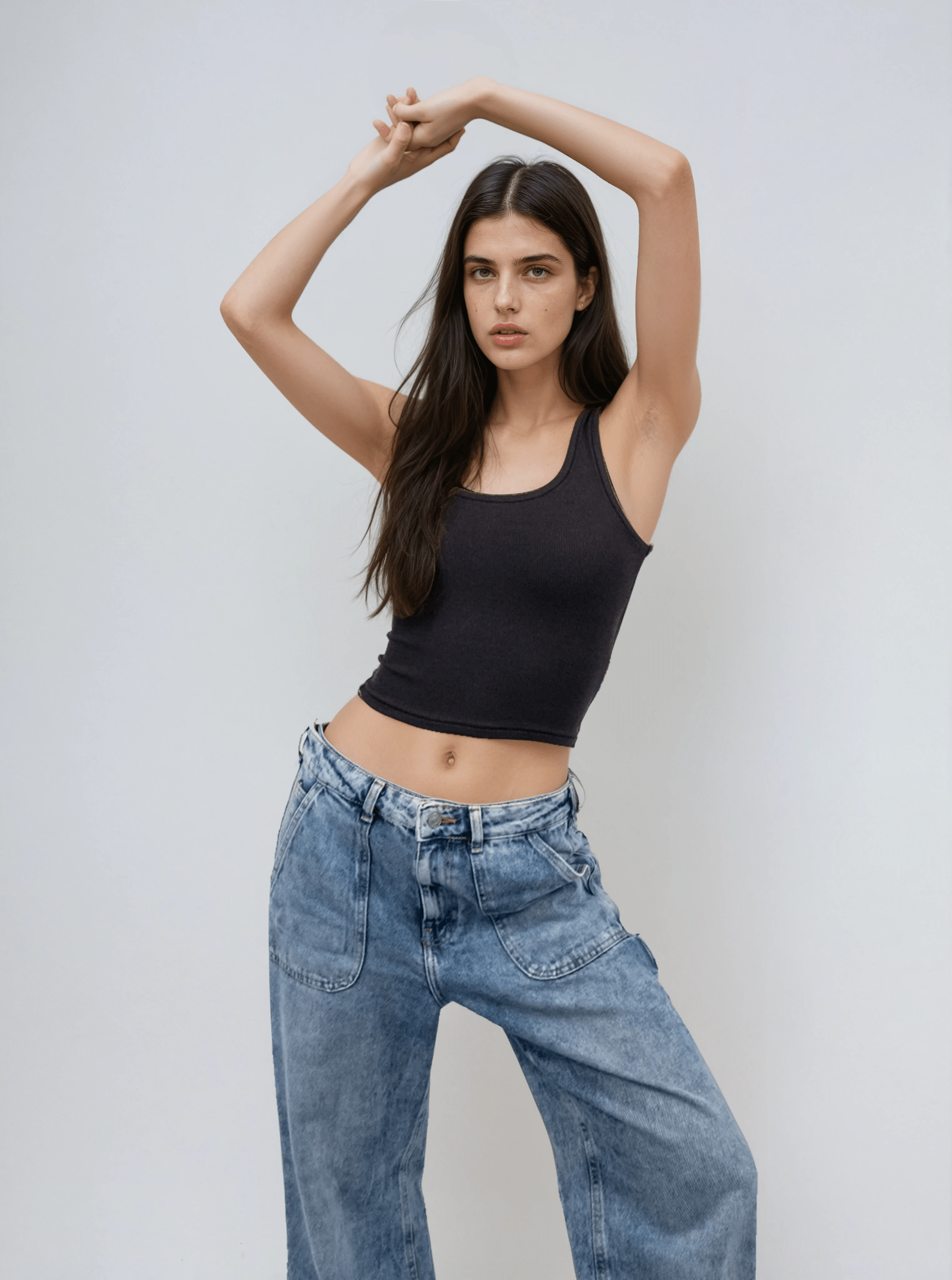 Black sleeveless body tank with scoop neck and thin straps, fitted at waist.
