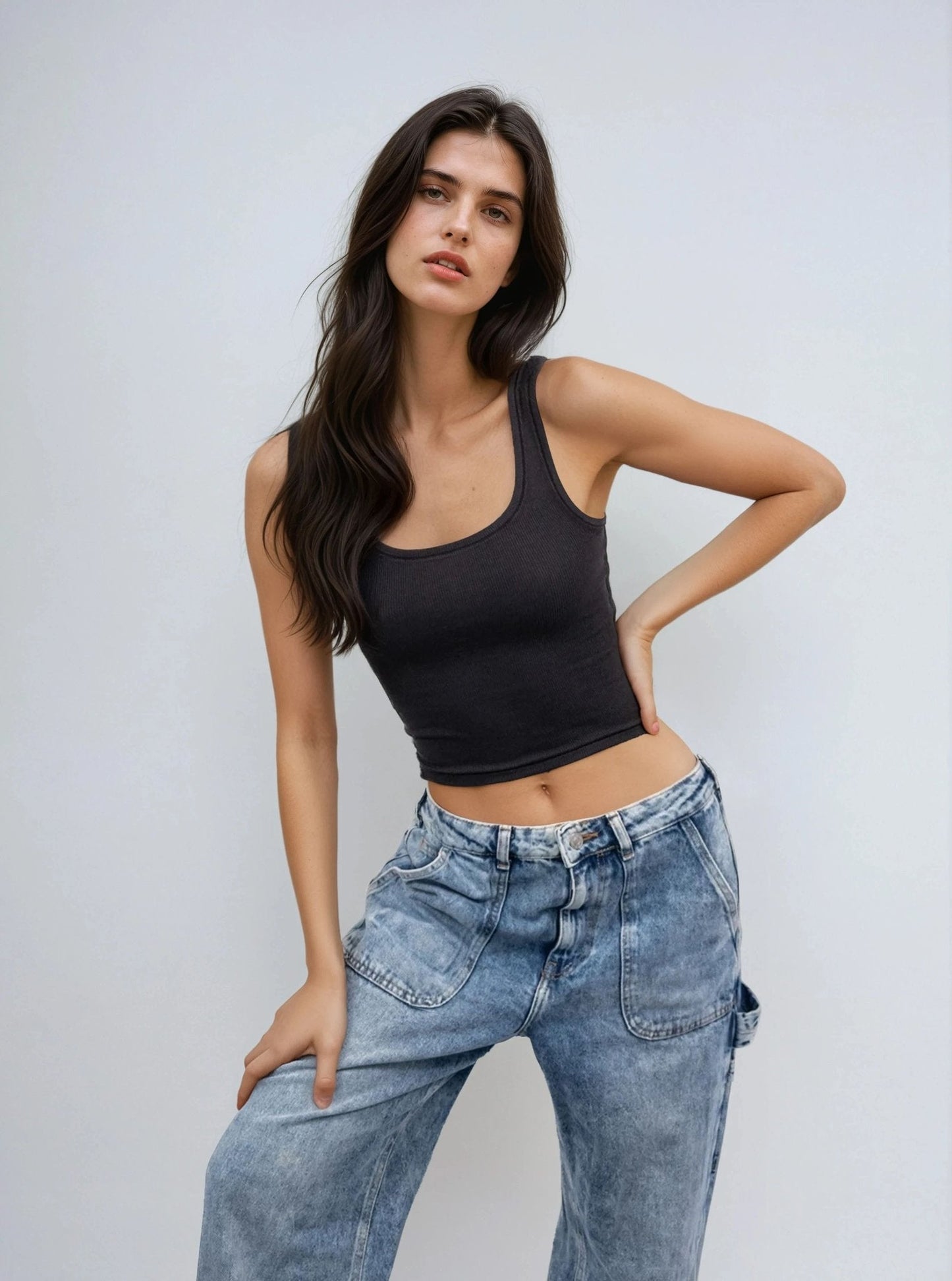 Black scoop-neck sleeveless body tank, fitted waist-length with thin straps.