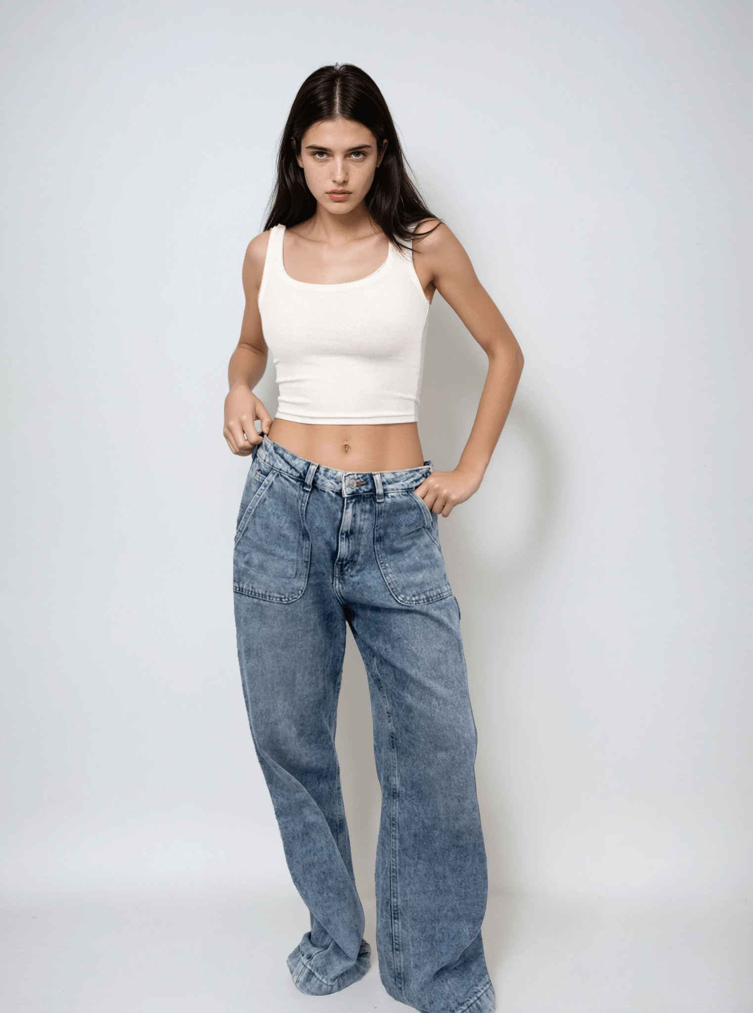 White scoop-neck sleeveless body tank, fitted close to torso, cropped length.