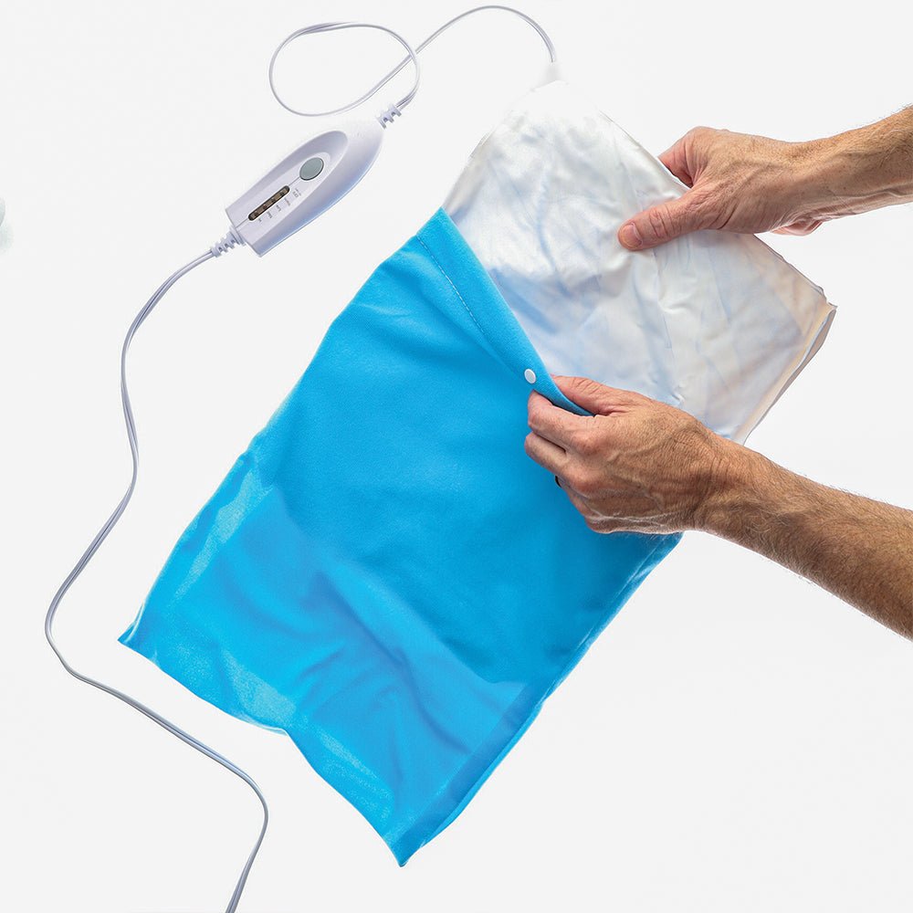 Blue heating pad with white sponge pad cover being lifted
