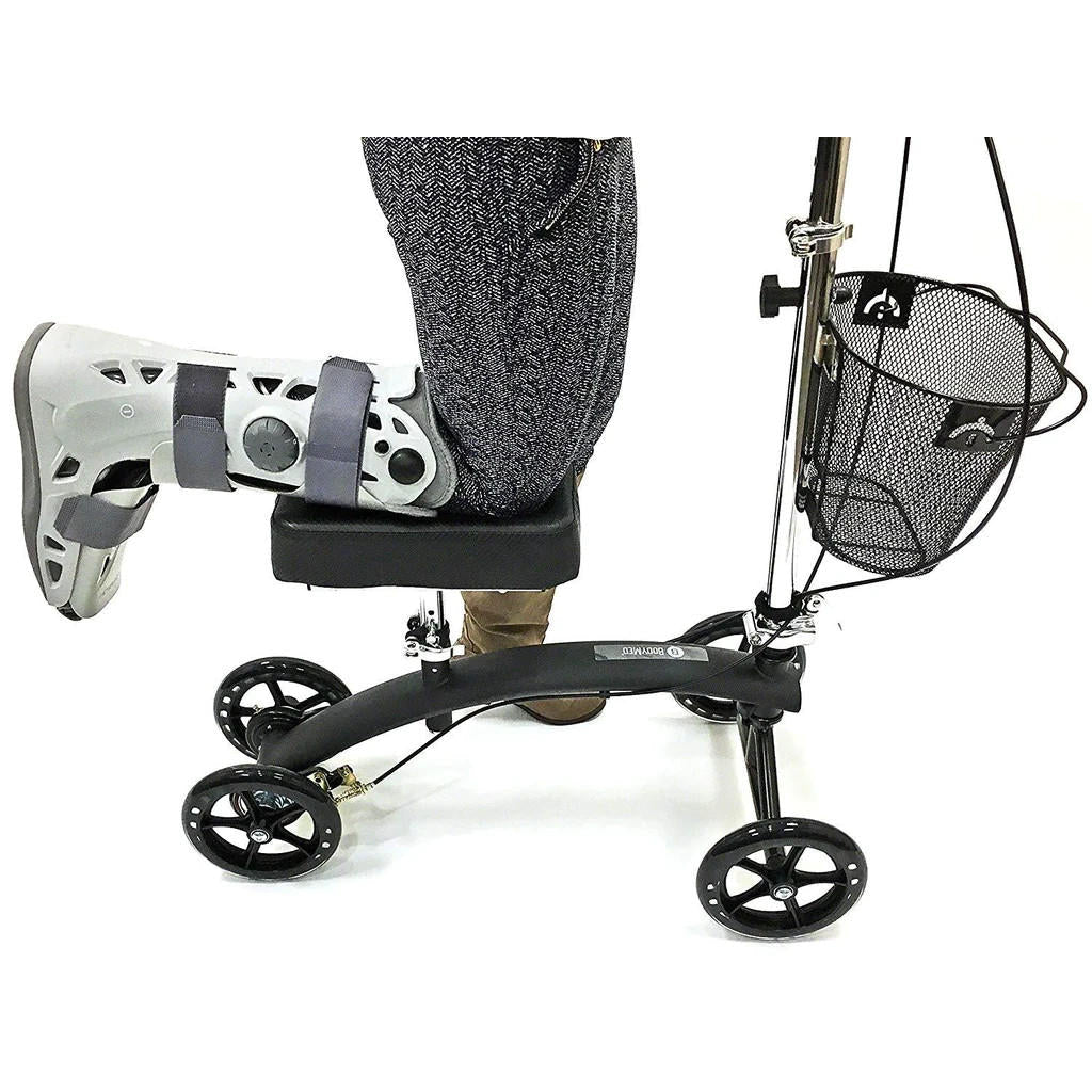 Knee walker close-up with padded knee support, foot platform, and front mesh basket