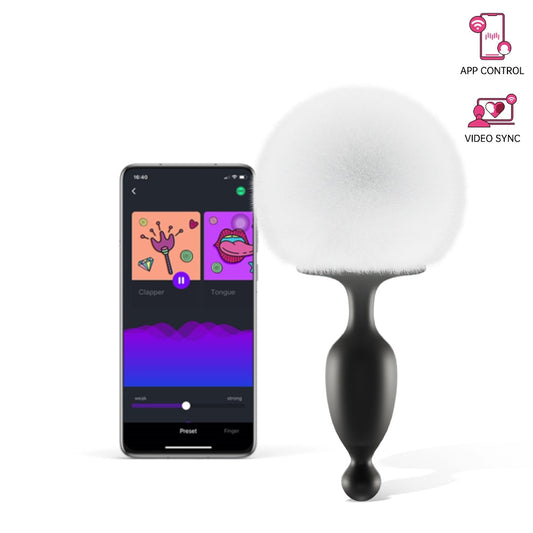 Bunny tail massager with black silicone body and white fuzzy pom, app-controlled