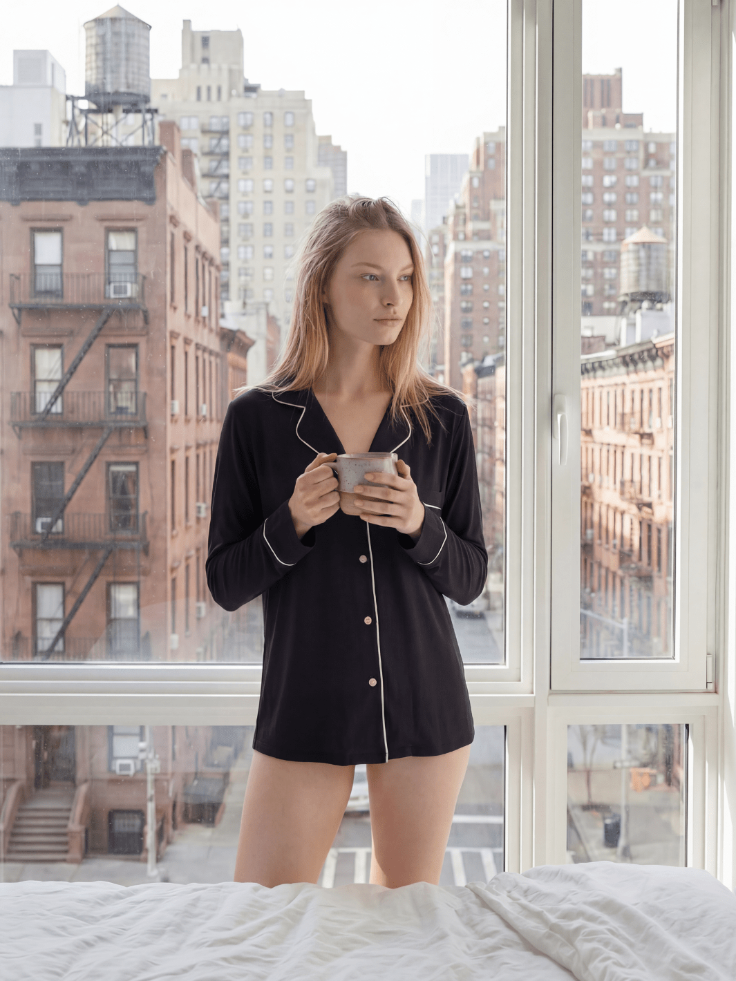 Black button-down pajama top with notch collar, white piping, and front buttons