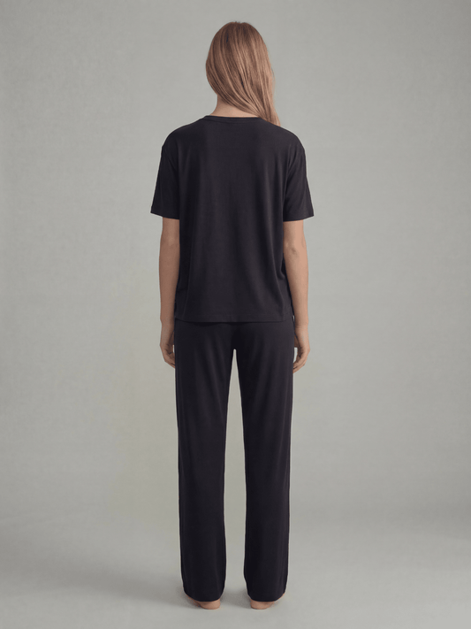 Black pajama pants, back view, elastic waist and wide-leg straight legs.