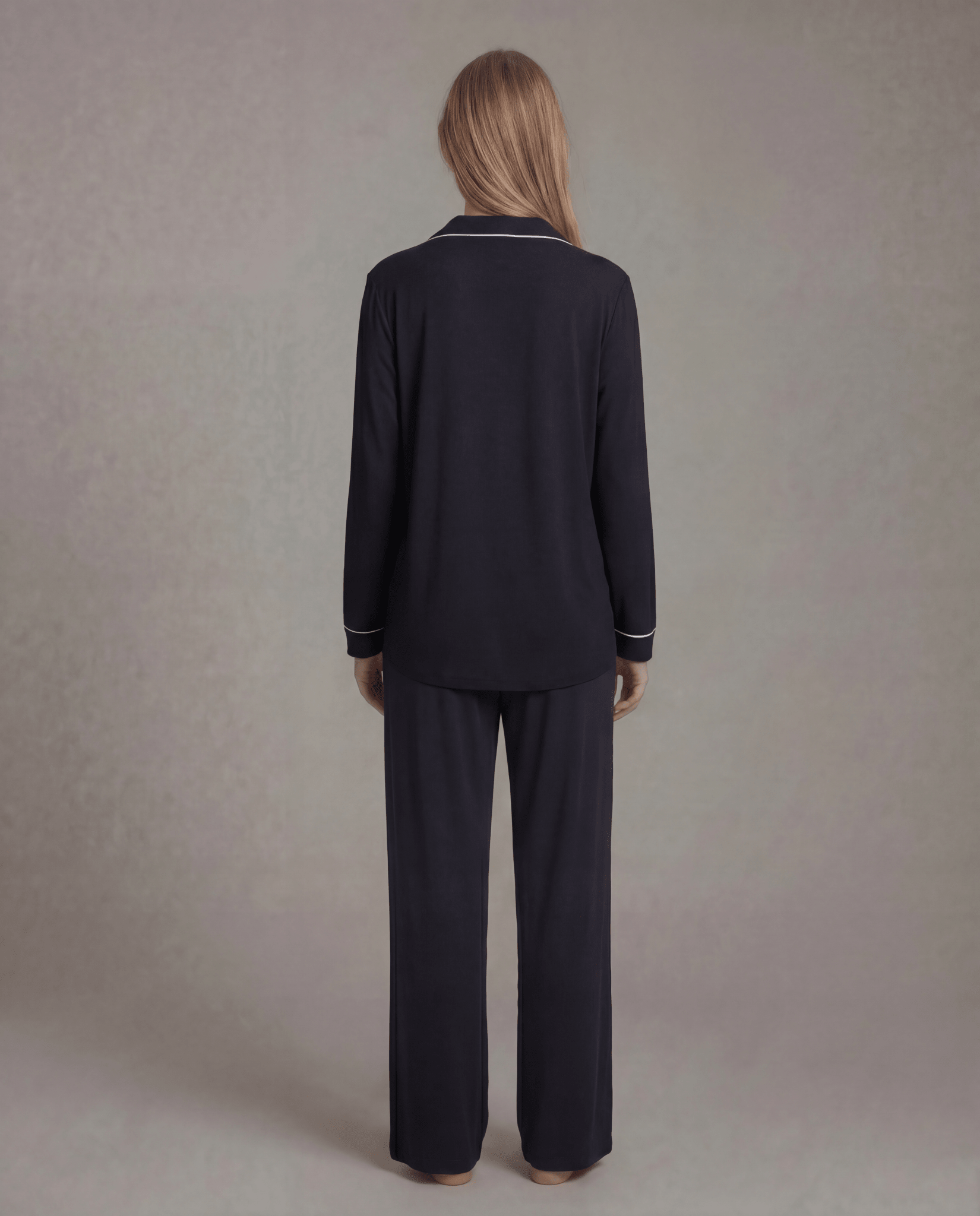 Black pajama set back view: long-sleeve button-down top and wide-leg matching pants.