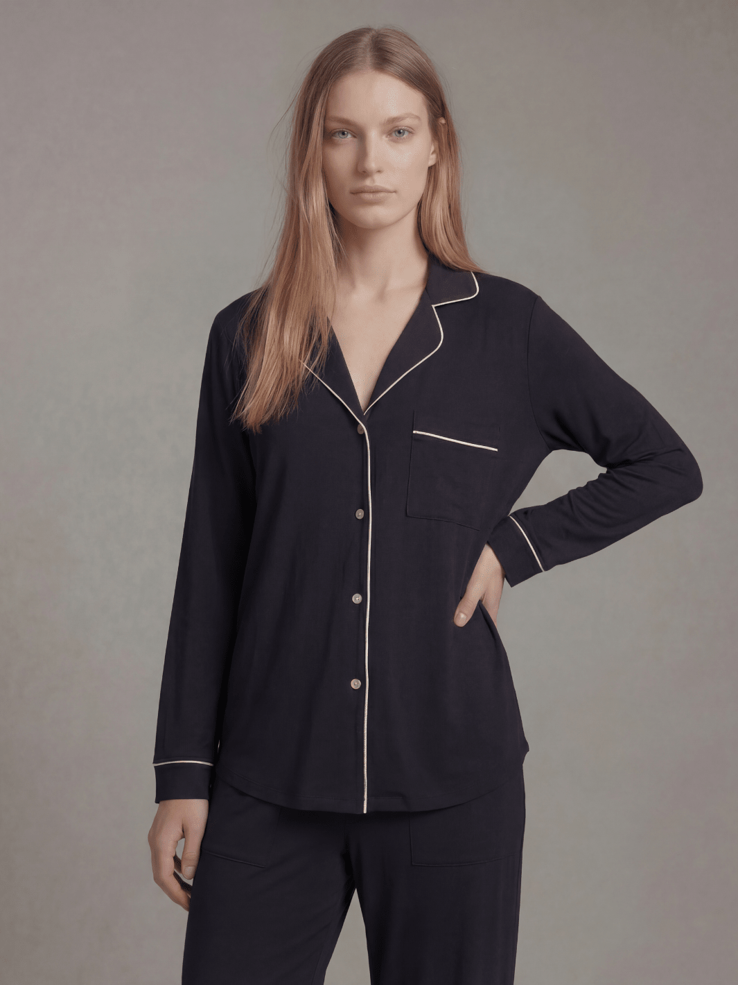 Black button-down pajama shirt with contrast piping and matching pajama pants, long sleeves.