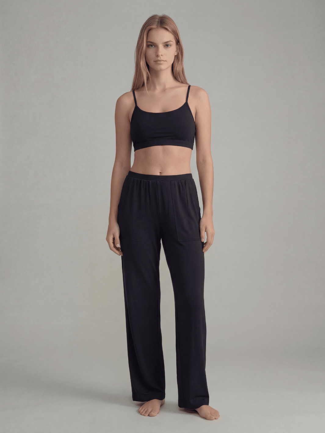 Black pajama set with thin-strap crop top and wide-leg pants