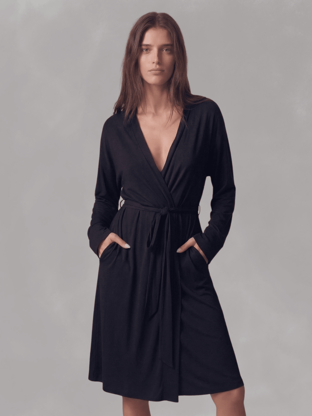 Black wrap robe with V-neck and belt tie, long sleeves, front view hands near waist