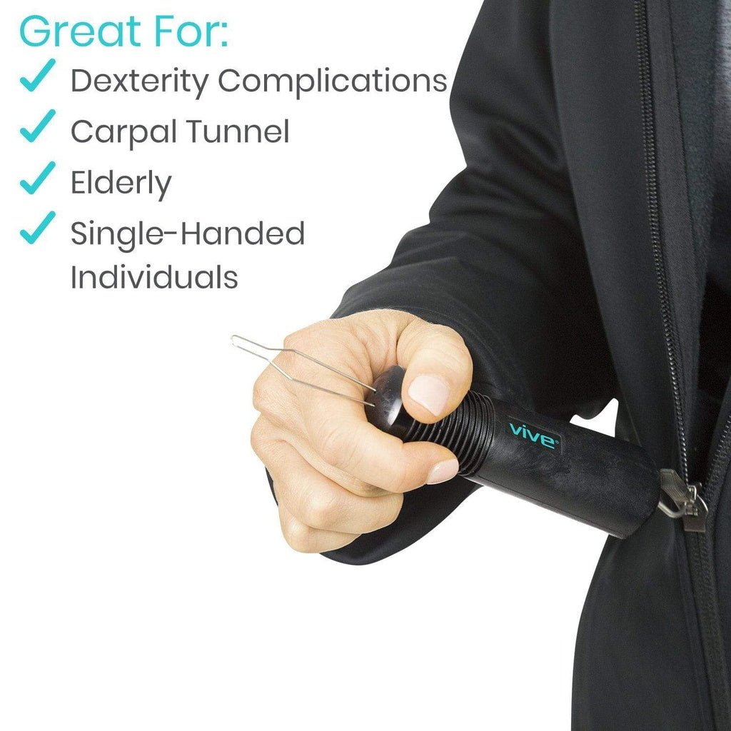 Black button hook held in hand, inserted near a dark jacket zipper
