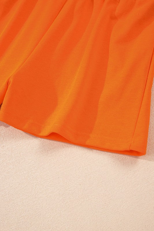 Mini skirt orange with soft pleated fabric and curved white hem trim