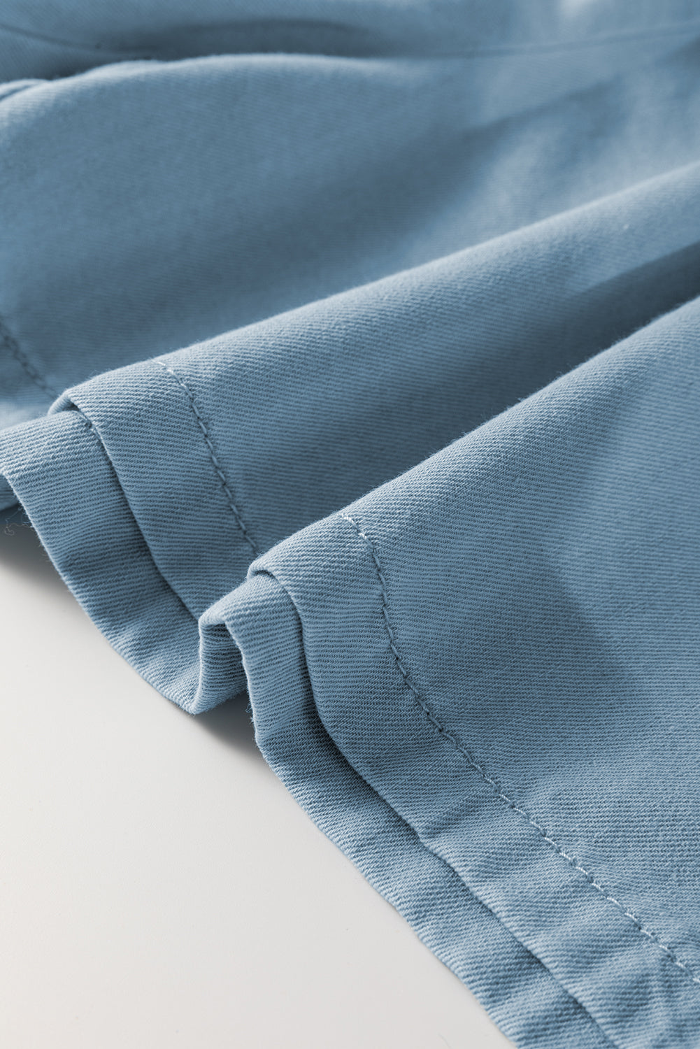 Washed chambray hem and stitching detail, blue