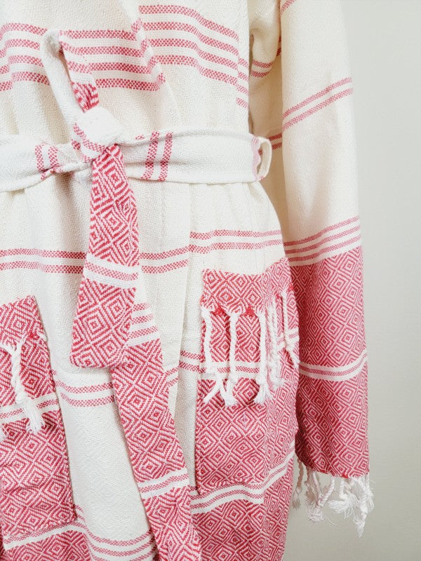 Unisex robe belt and pocket close-up with red-and-white stripe patterns and tassel trim