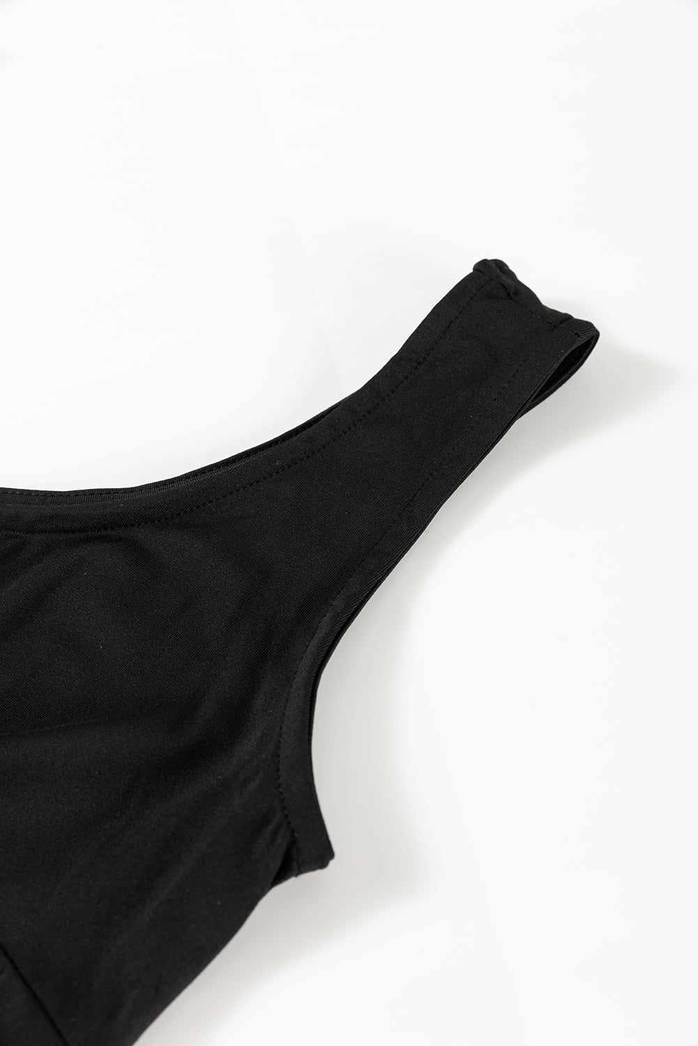 Black tank-style dress neckline and shoulder strap close-up