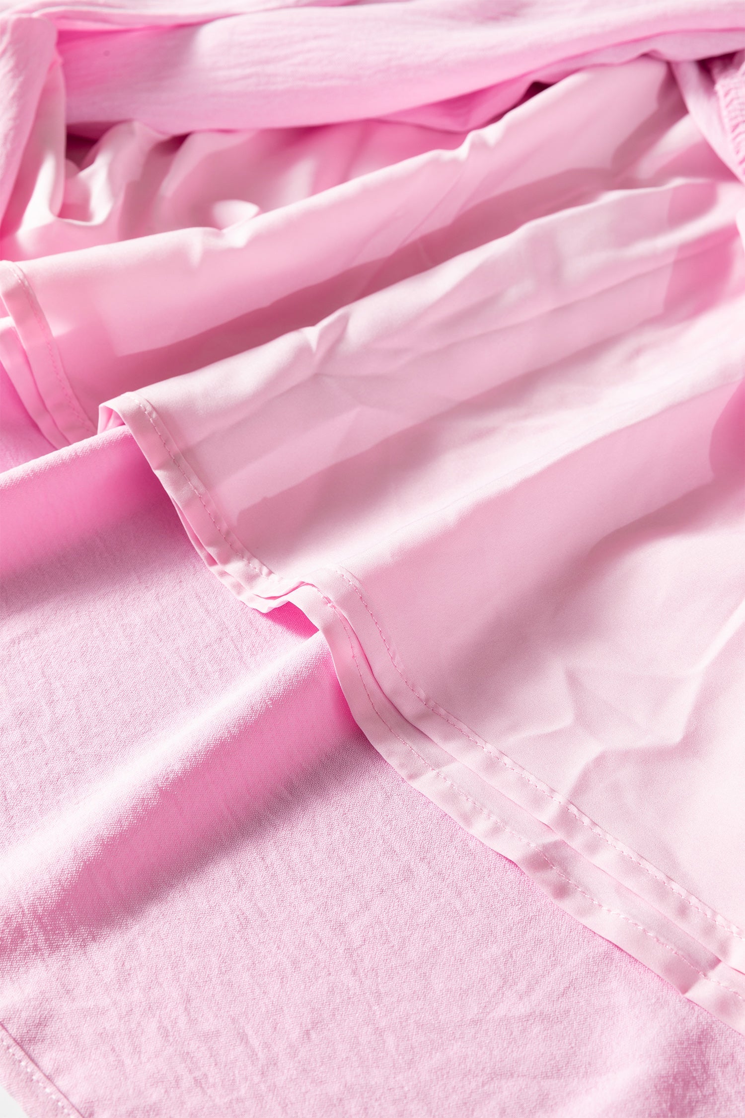 Pink tiered midi dress close-up of ruffled layers and gathered bodice trim