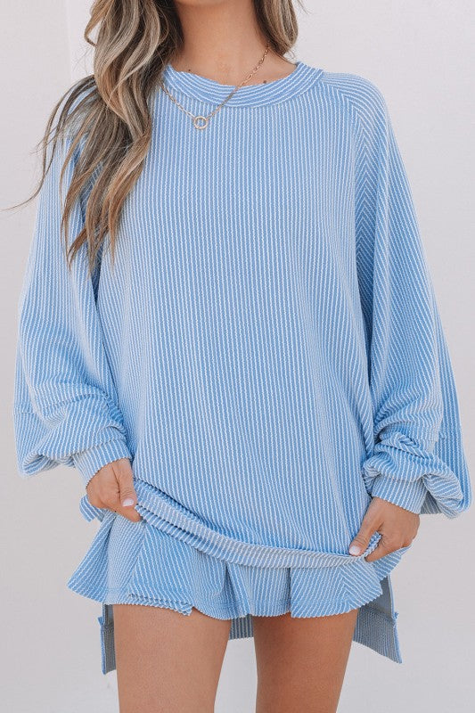 Light blue corded top and ruffle mini skirt set, crew neck, ruffle hem, close-up