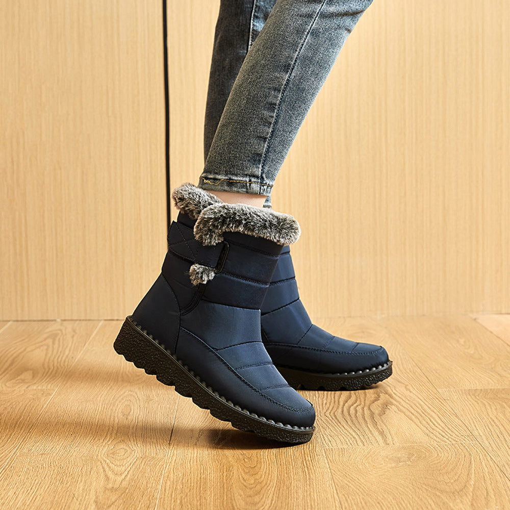 Dark blue ankle snow boots with faux-fur trim, hook-and-loop strap, rugged tread sole