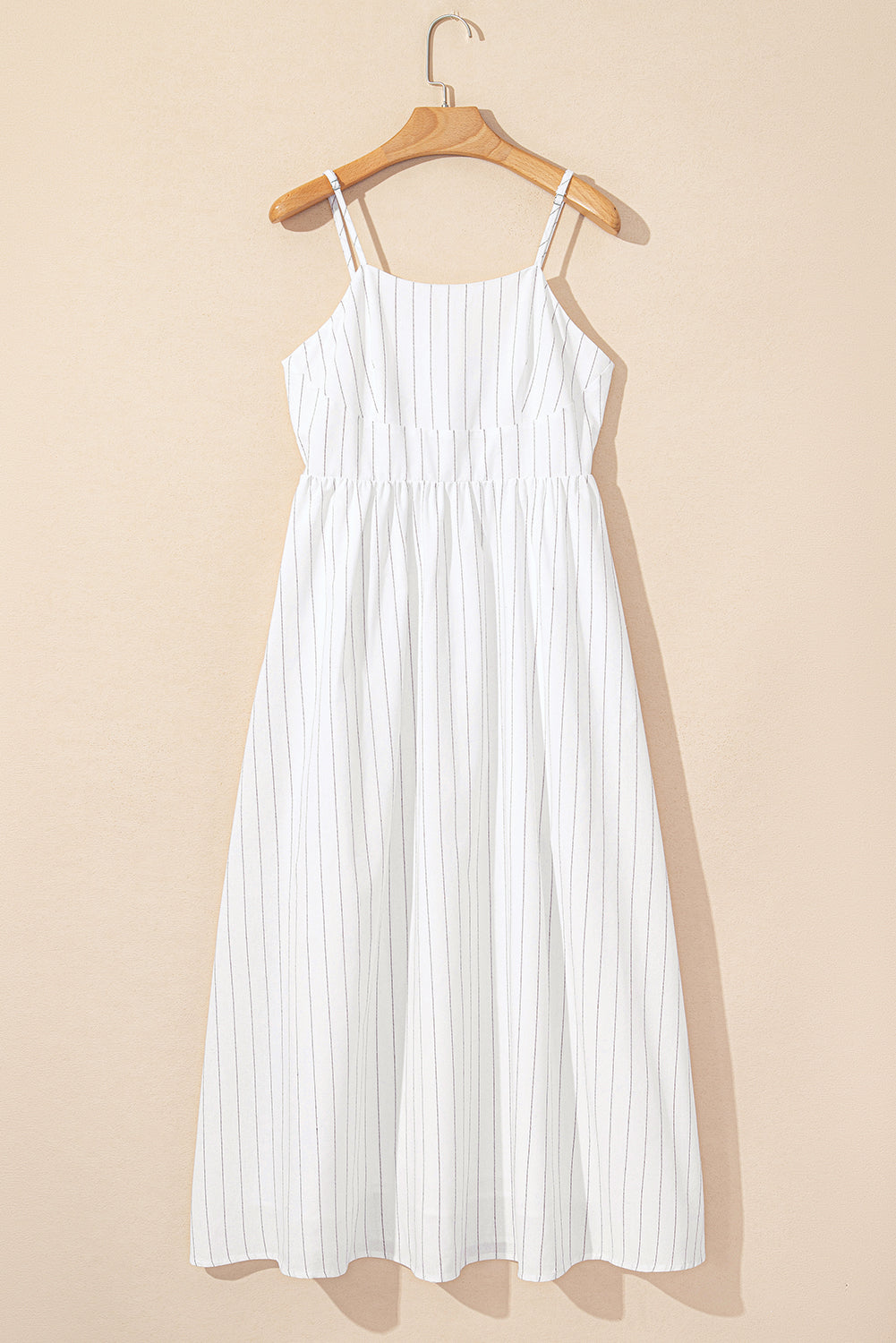 White pinstripe spaghetti-strap maxi dress on hanger, sleeveless with scoop neckline