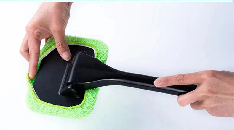 Car window cleaning brush with light green microfiber pad and black scraper frame