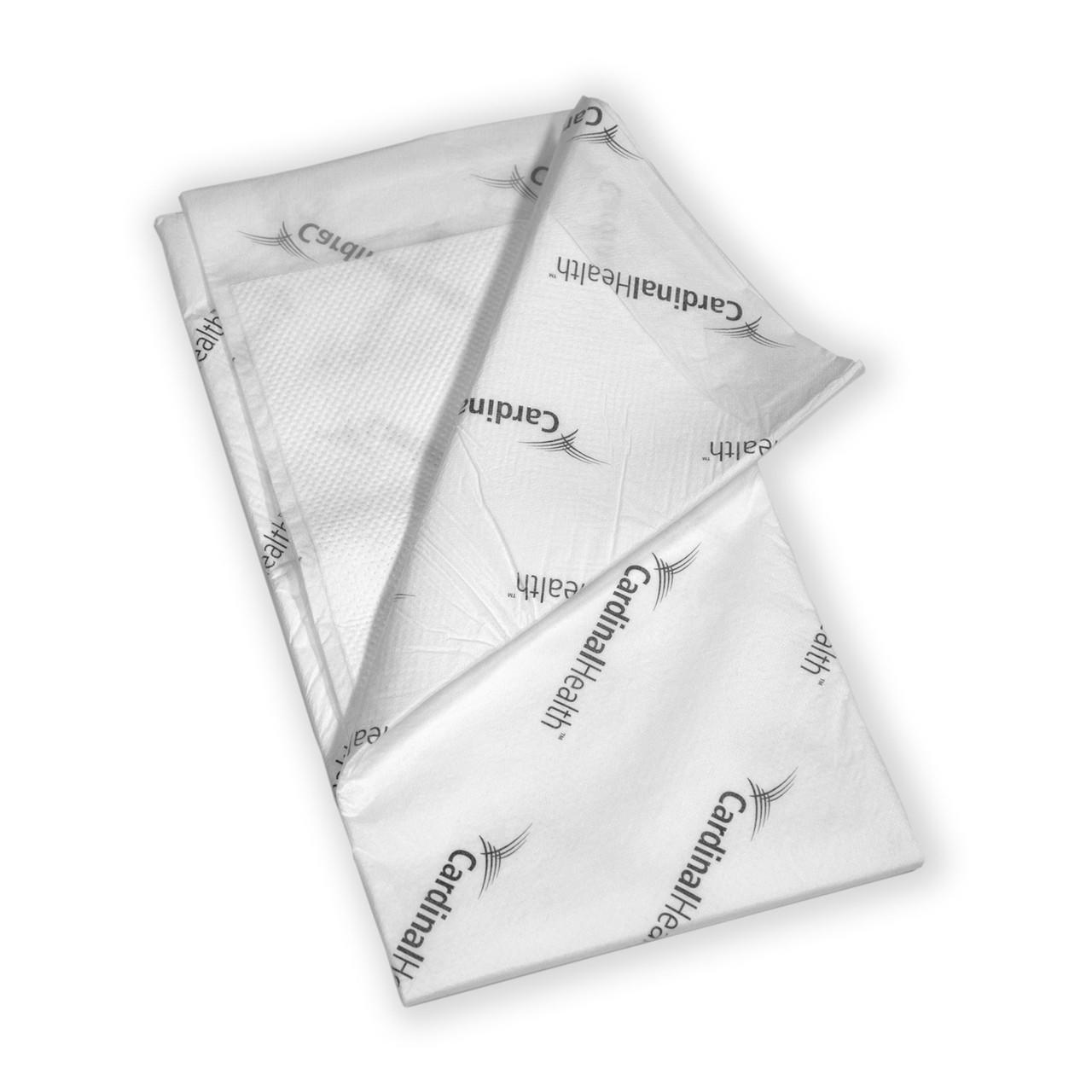 White quilted underpads with wings, folded—40 x 57 in
