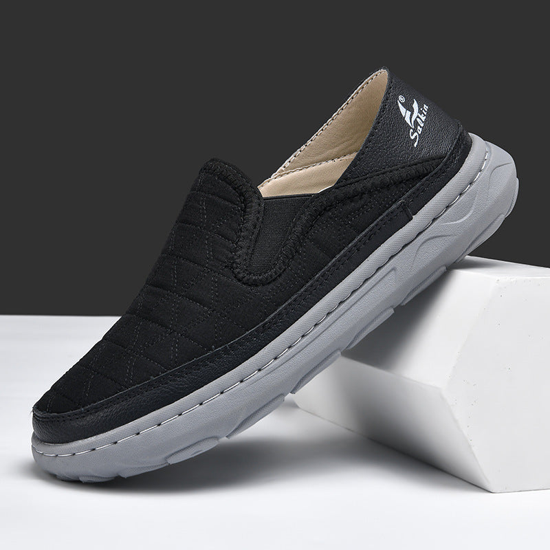 Men's casual travel slip-on shoes in black, suede-like upper with cushioned gray sole