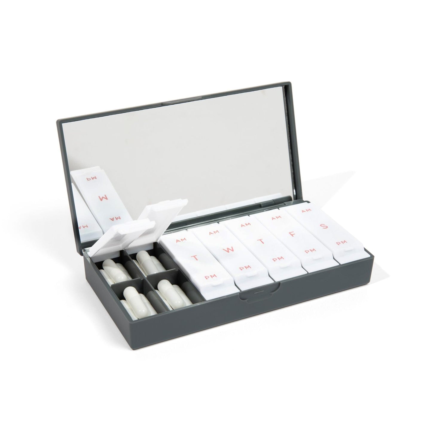 Charcoal gray AM/PM pill box open with labeled compartments and white pill slots
