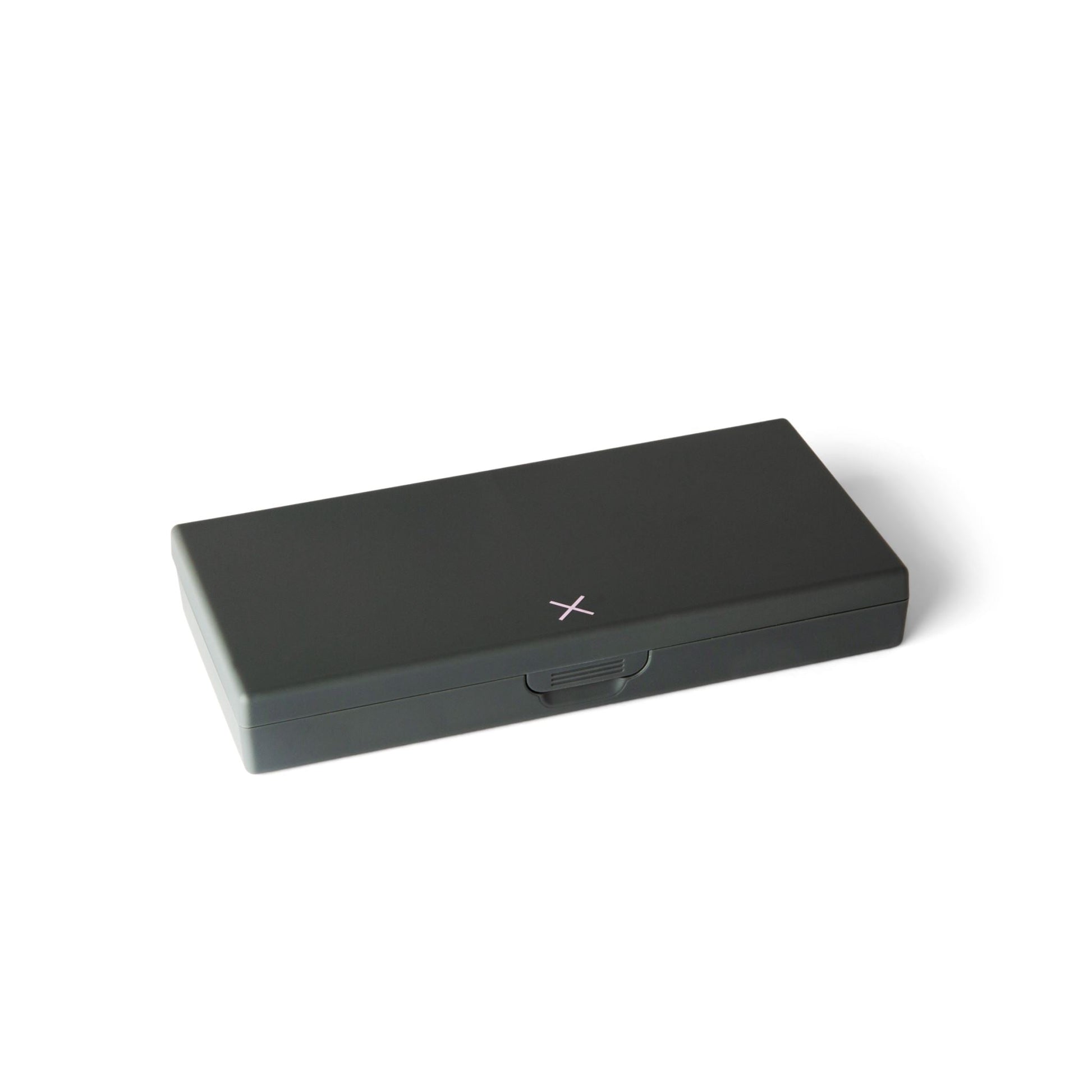 Charcoal gray pill box with flip-top lid closed and small center latch mark