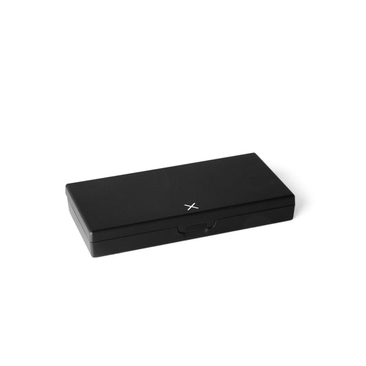 Black rectangular pill box closed with center latch and X logo