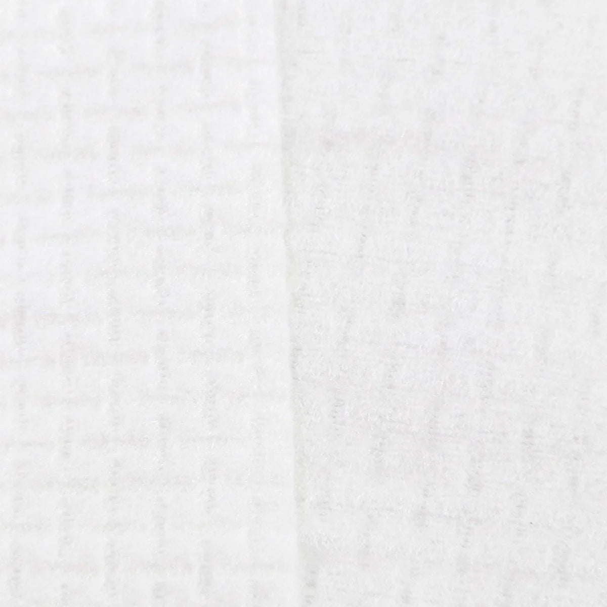 Close-up of white face towel fabric with subtle ribbed texture