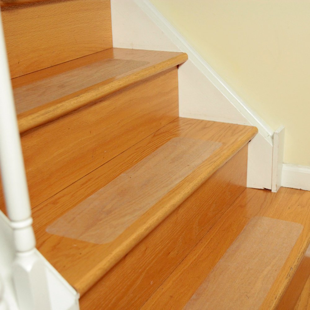 Clear anti-slip stair tread sheets on wooden steps, transparent grip surface