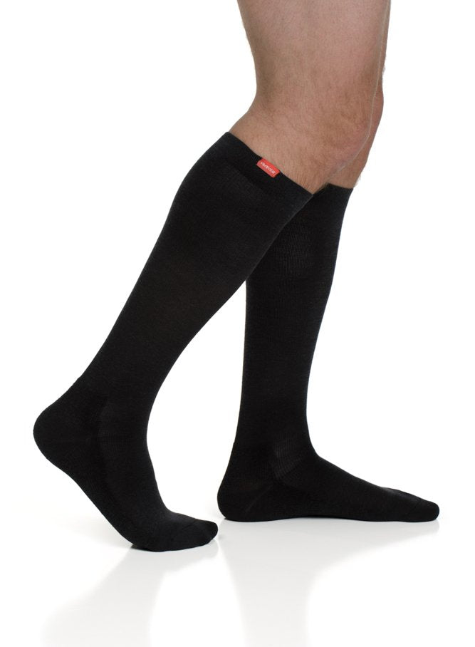 Black cotton compression crew socks with logo patch at cuff, side view