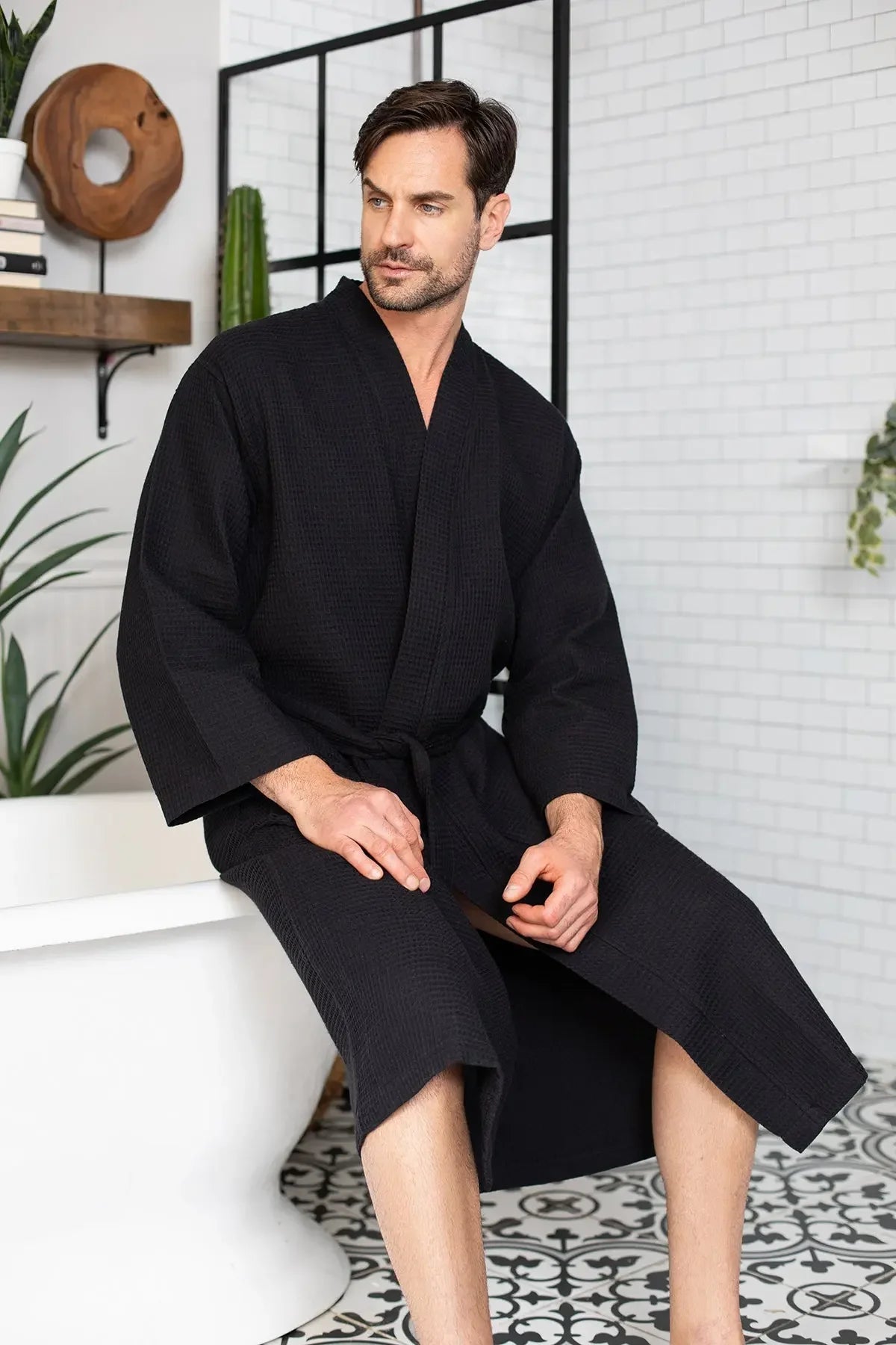 Men's waffle spa bathrobe in dark charcoal, belted V-neck waffle-knit robe with long sleeves.