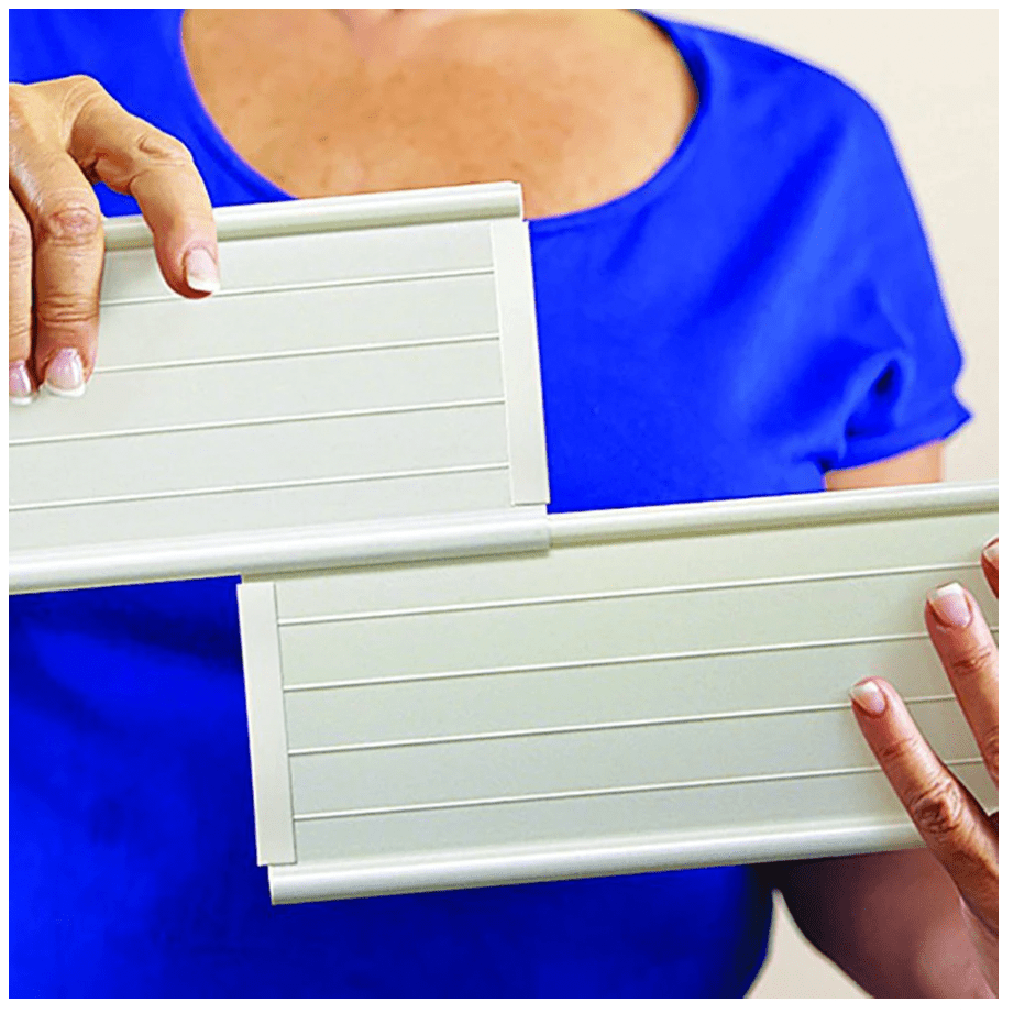 Hands installing light gray sofa support cushion slats on seat