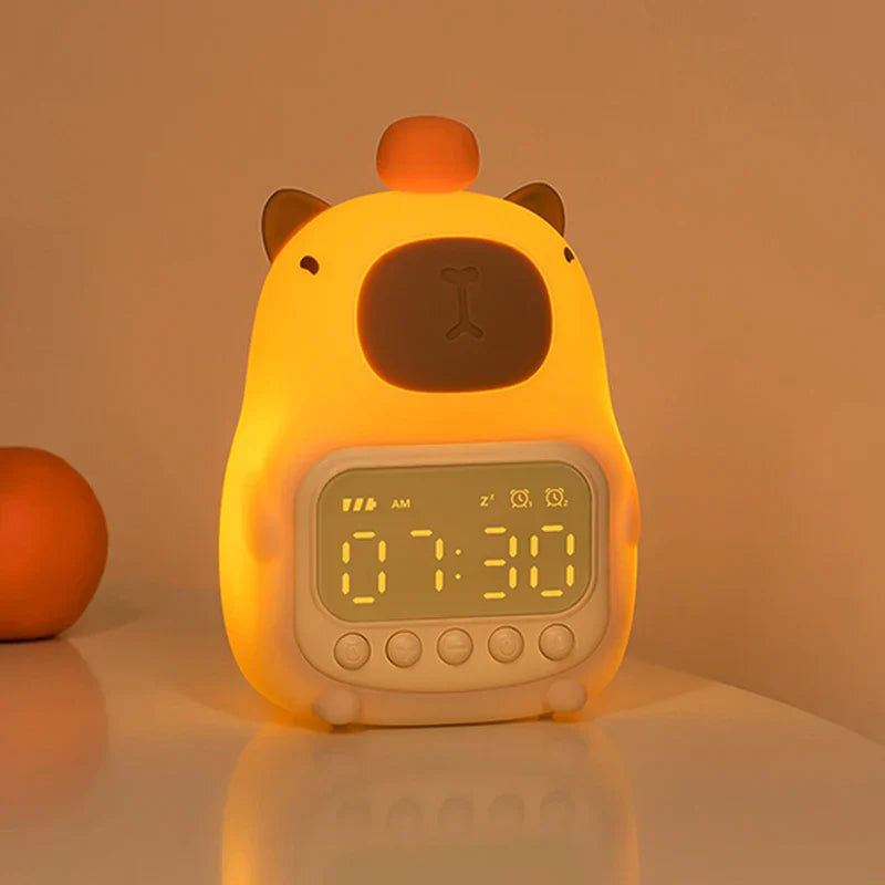 Capybara night light alarm clock, front view with bright warm glow and digit display